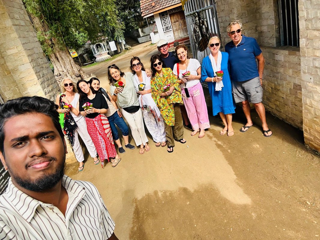 Cultural heritage group tour at a sacred Buddhist temple in Kandy, Sri Lanka.