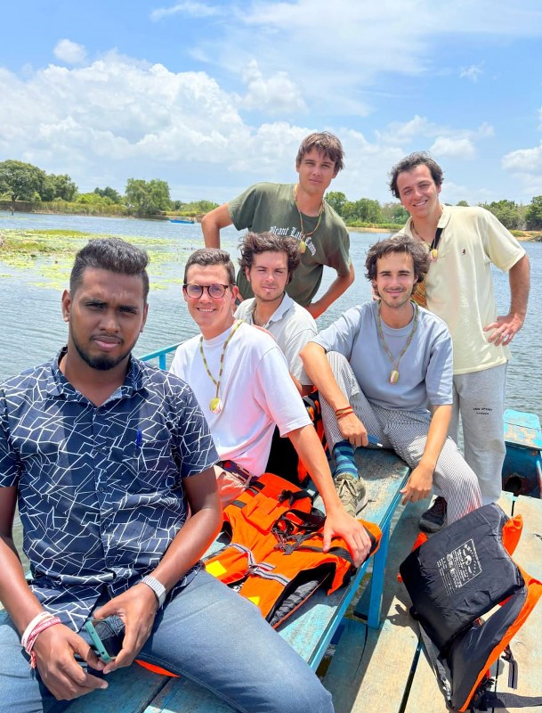 Adventure travelers enjoying a traditional lake boat safari experience in Sri Lanka.
