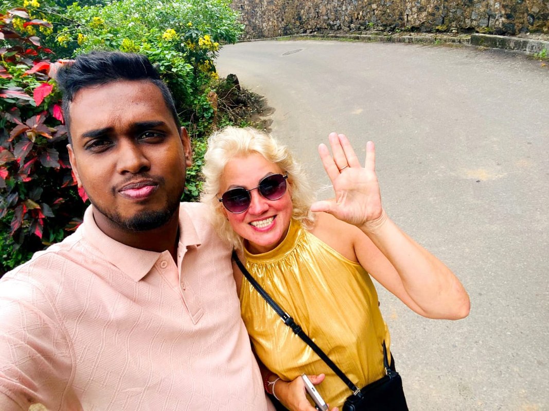Tourists enjoying natural mountain streams and river views in Ella, Sri Lanka.